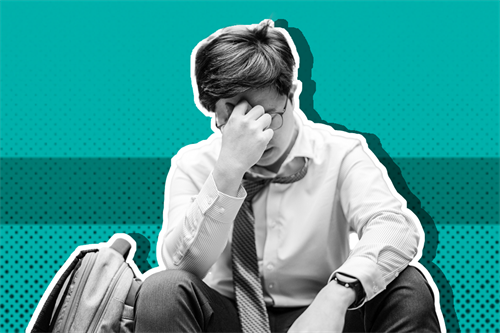 Man sat down with hand on his face