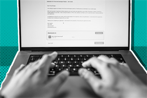 Close up of hands typing on a laptop