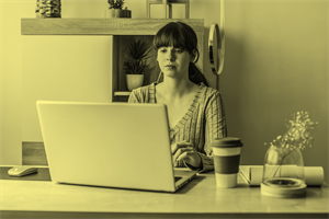 Woman sat in front of a laptop at home