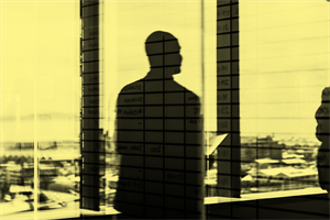 Shadow of a man standing by a window