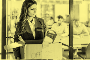 Person leaving an office holding a box