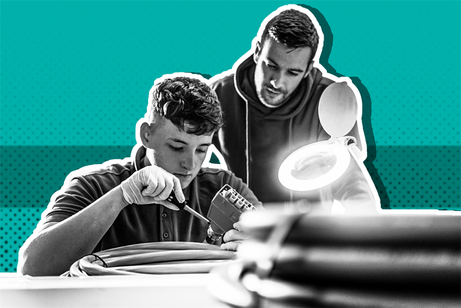 Two people fixing car parts