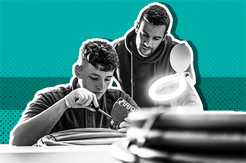 Two people fixing car parts