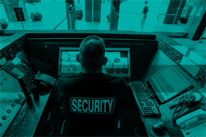 Security employee sat at a screen