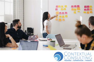 team meeting looking at post it notes on the wall